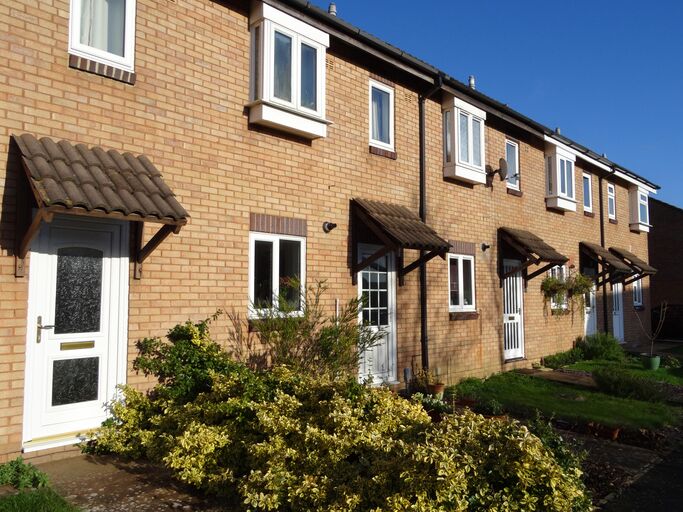 White uPVC front door on a brick terrace of houses