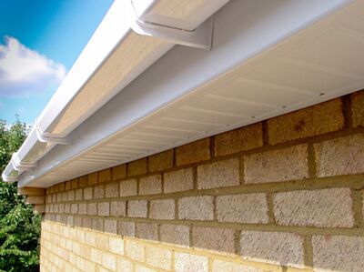 White fascia, soffit and guttering fitted to a brick building